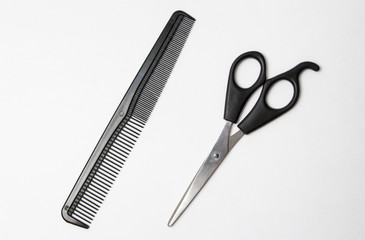 scissors and comb isolated on white