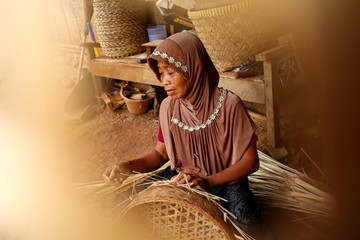 bamboo basket craftsman while doing his work in a place, Batang / Jawa Tengah - Indonesia, May 26,...