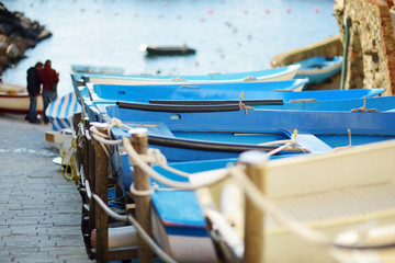 Colourful boats in tiny marina of Riomaggiore, the largest of the five centuries-old villages of Cinque Terre, Italian Riviera, Liguria, Italy.