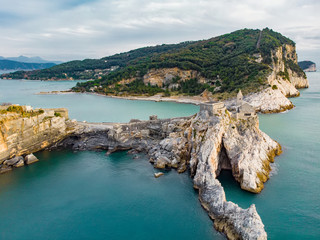 Aerial view of the Gothic-style Church of St. Peter sitting atop a rocky headland in Porto Venere...