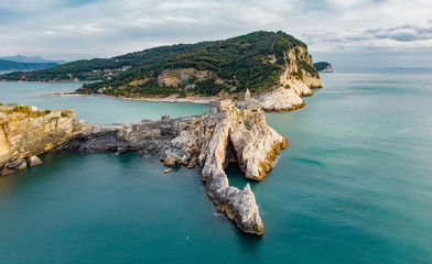 Aerial view of the Gothic-style Church of St. Peter sitting atop a rocky headland in Porto Venere...