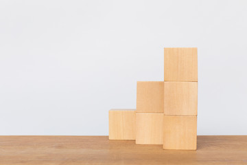Wooden cube stack a staircase on white background. Concept of success, winner, victory or top ranking