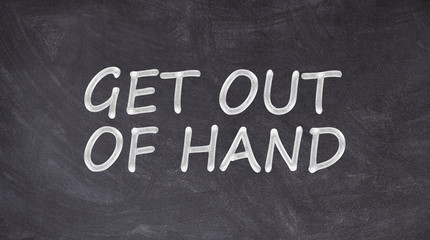 Obraz premium Get out of hand written on blackboard