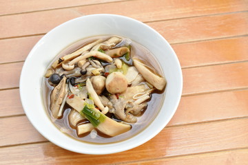 boiled spicy mixed mushroom and gourd soup on bowl