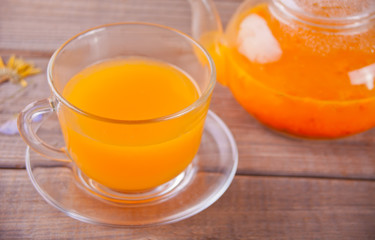 Sea buckthorn tea in a glass cup. Herbal vitamin tea.