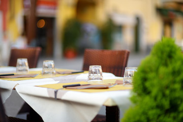Beautifully decorated small outdoor restaurant tables in the city of Lerici, Italy