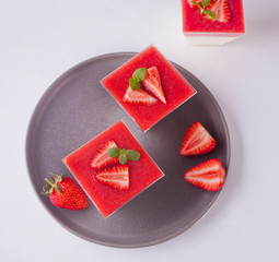 Dessert panna cotta with fresh strawberries on white background, selective focus