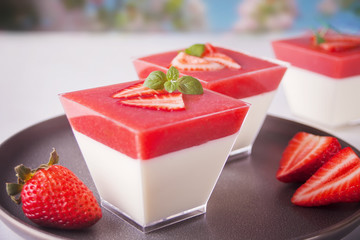 Dessert panna cotta with fresh strawberries on plate, selective focus