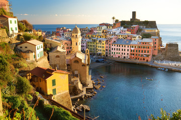 Fototapeta na wymiar Colourful houses and small marina of Vernazza, one of the five centuries-old villages of Cinque Terre, located on rugged northwest coast of Italian Riviera.