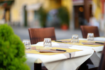 Beautifully decorated small outdoor restaurant tables in the city of Lerici, Italy