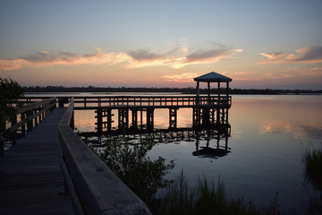 Fototapeta na wymiar Sunsets Reflecting Bridges and Docks on Florida Waters at Dusk in Ormond Beach