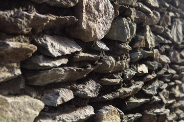 Old grey granite wall built of ancient stonework, abstract background with place for text.