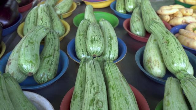 Dolly in on selection of zucchini at brazilian free fair (Farmer Market) on the street