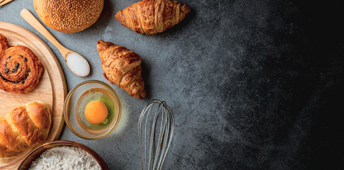 Freshly baked bread on wooden table,Bakery Concept- gold rustic crusty loaves of bread and buns on...