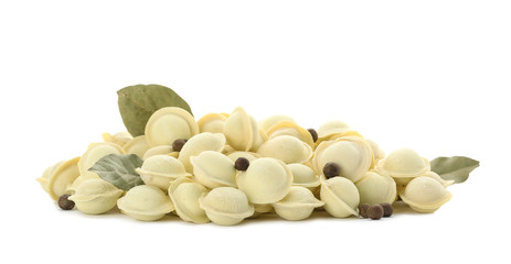 Raw meat dumplings with bay leaves and pepper on white background