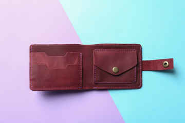 Stylish wallet on color background, top view