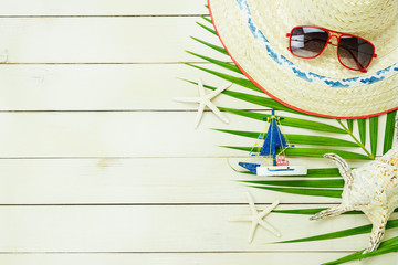 Table top view accessory of clothing women  plan to travel in summer holiday background concept.boat with many essential items sunglasses & hat on modern rustic white wooden.Space for design.