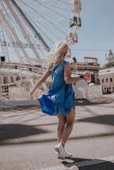 Naklejka premium Woman happy running in summer dress. Italy. Lifestyle. Girl smiling laughing joyful having fun. Walking on city street. Sundress. Fashion. Urban style