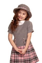 Studio shot of a lovely little kid with a long, curly hair posing isolated on white background.