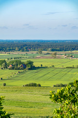 View over the Elbauen in Lower Saxony, Germany. You see a landscape with fields, meadows and trees.