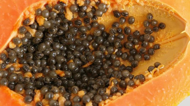 Top view of ripe half cut papaya, flat lay. Rotate. Healthy summer food concept with tropical fruit, flat lay