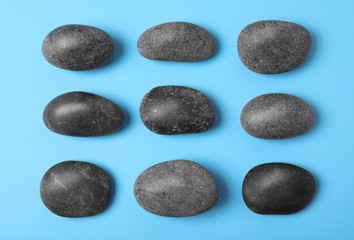 Spa stones on color background, flat lay