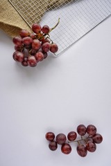 Ripe red grape and Pink bunch isolated on white background, top view