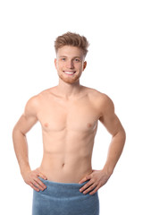 Fototapeta premium Portrait of young man with slim body in towel on white background