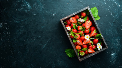 Fresh strawberries in a wooden box. Berries Top view. Free space for your text.