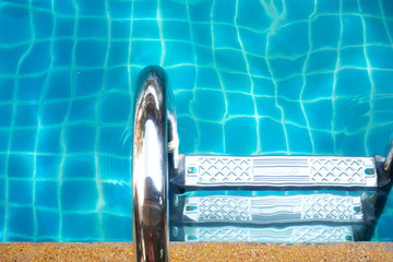 Stainless rail in swimming pool. Water activity.