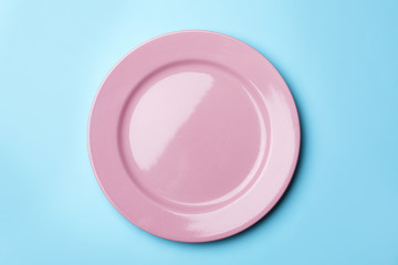 Stylish ceramic plate on color background, top view