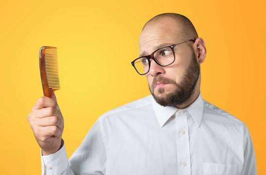 Adult Bald  Man Hand Holding Comb