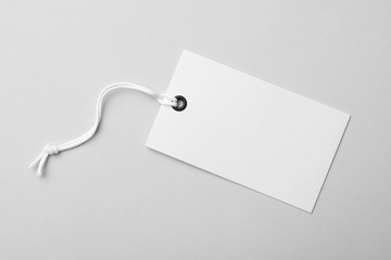 Cardboard tag with space for text on light background, top view