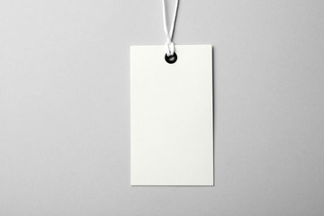 Cardboard tag with space for text on light background, top view