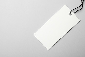 Cardboard tag with space for text on light background, top view