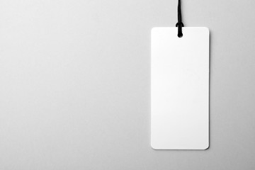 Cardboard tag with space for text on light background, top view