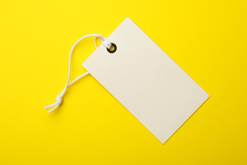 Cardboard tag with space for text on color background, top view