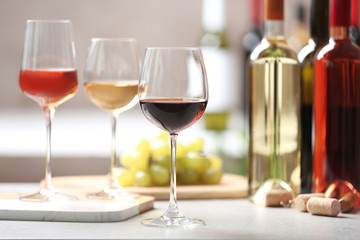 Different glasses with wine served on table
