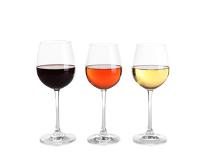 Glasses of different wine on white background