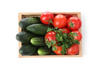 Wooden crate full of fresh vegetables on white background, top view