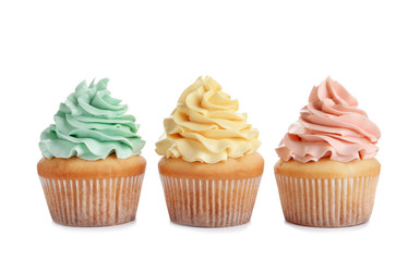 Delicious cupcakes with cream on white background