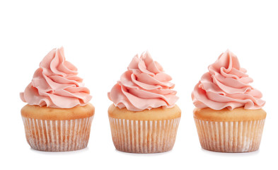 Delicious cupcakes with cream on white background