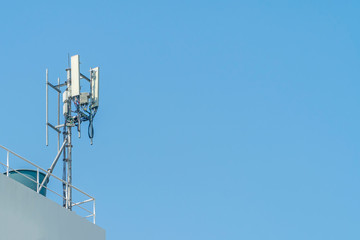 Cellular phone towers are on the rooftop of the building.
