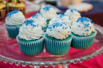 Blue cupcakes with frosting and sprinkles
