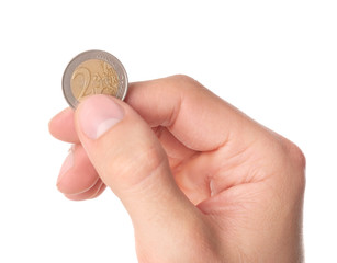 Man holding coin in hand on white background, closeup