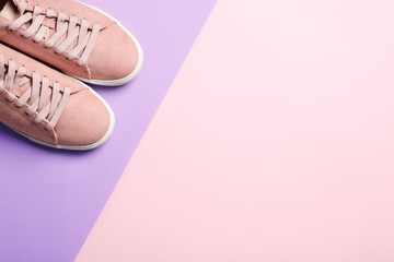 Bright stylish shoes on color background, top view. Space for text
