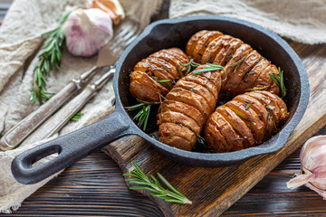 Frying pan with roasted potatoes and rosemary.