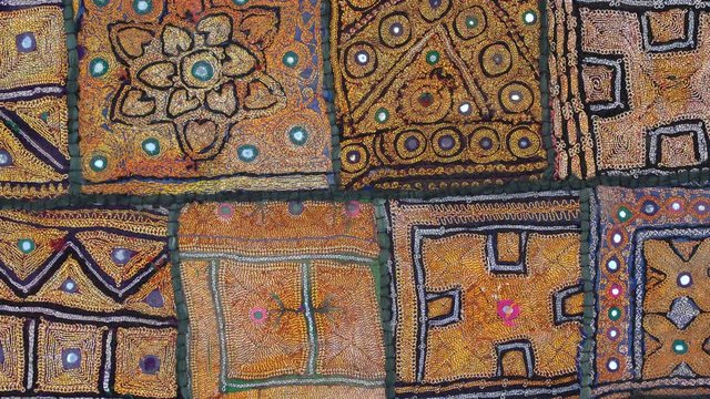 Detail old colorful patchwork carpet, establishing shot. Close up