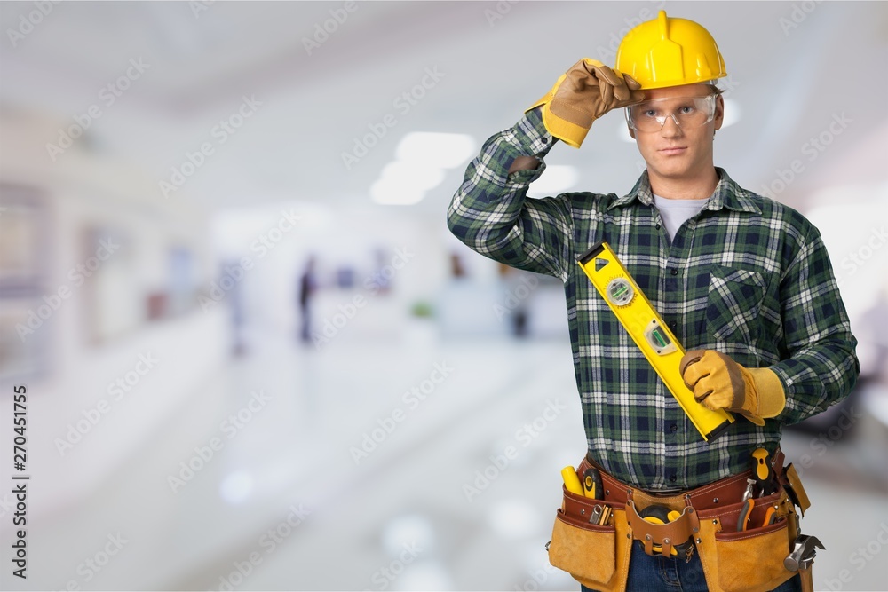 Wall mural Male worker with tool belt isolated on   background