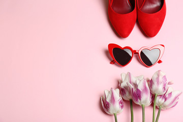 Flat lay composition with heart shaped sunglasses on color background, space for text